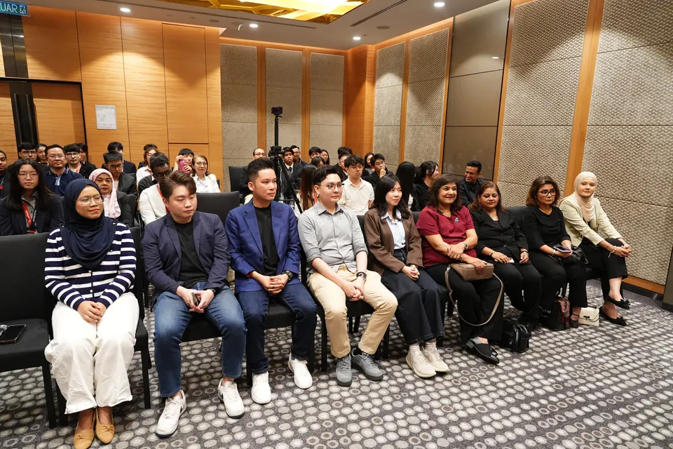 Participants and guests seated together in a meeting room at the 2026 Tech Hackathon