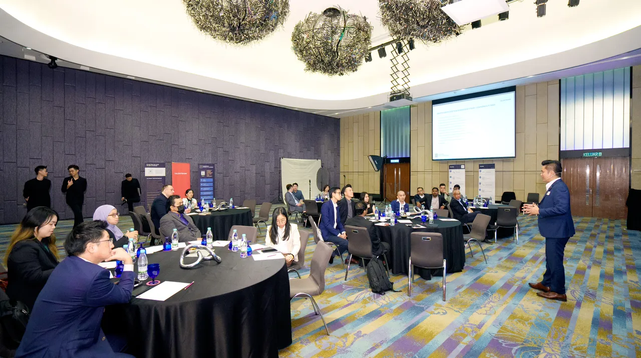 Business leaders seated at round tables in a hotel ballroom, listening to a speaker at a Talentbank industry session