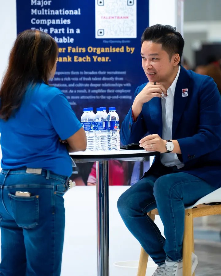 The author in conversation with a visitor at the Talentbank Career Fair stand, National Career Fair 2025