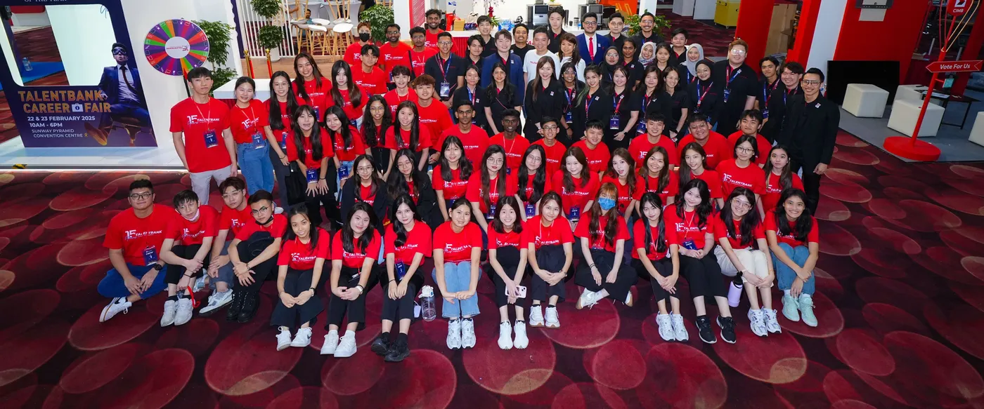 The Talentbank team in red event shirts gathered for a group photo at a career fair