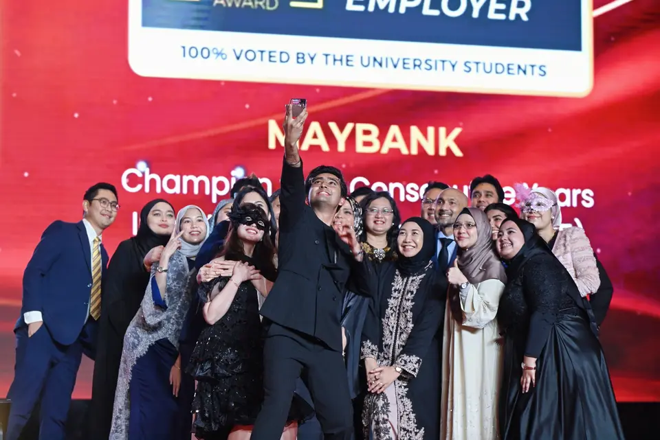 A winning team celebrating on stage in 2025