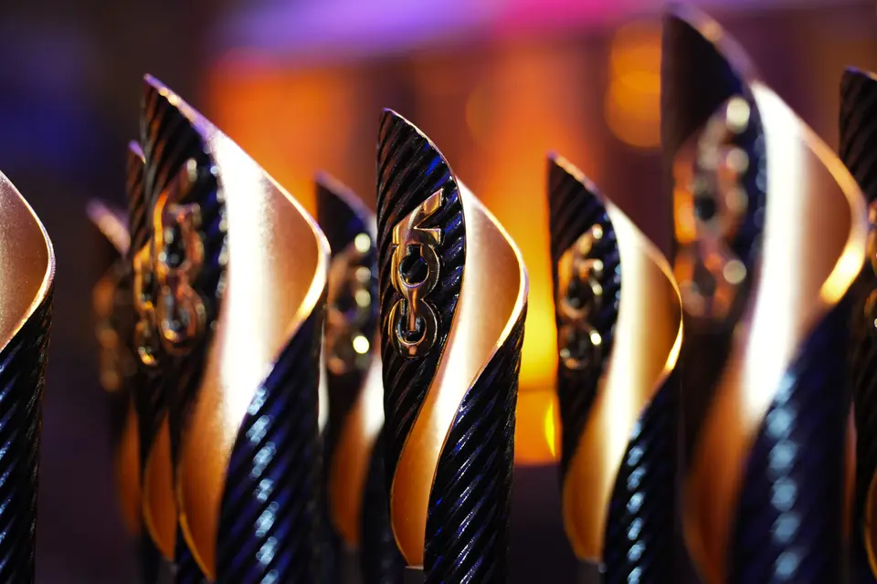 Graduates' Choice Award trophies in a row, black and gold