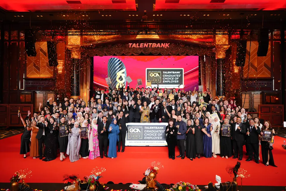 Winners holding their awards on stage at a Graduates' Choice Award gala