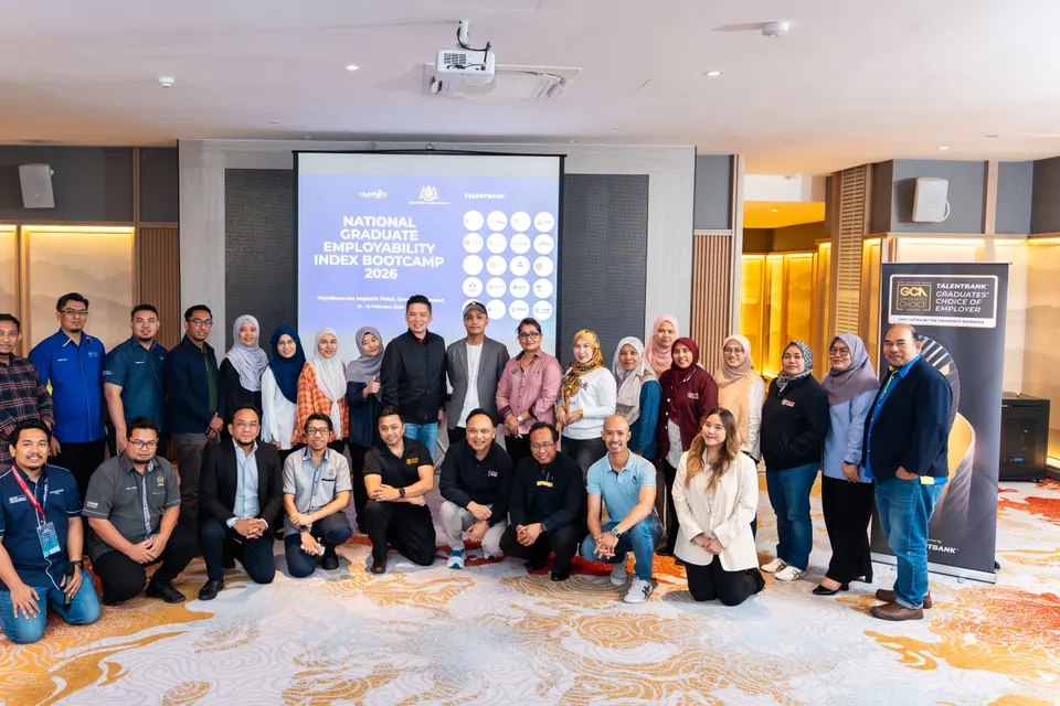 Participants of the National Graduate Employability Index Bootcamp 2026 posing for a group photo beside the programme screen and a Talentbank banner