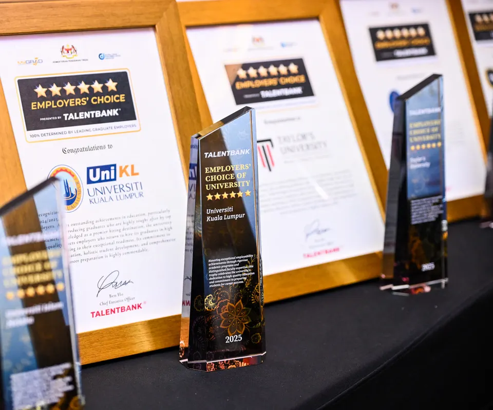 A framed Employers' Choice certificate and a glass Employers' Choice of University trophy on a table at the 2025 award ceremony