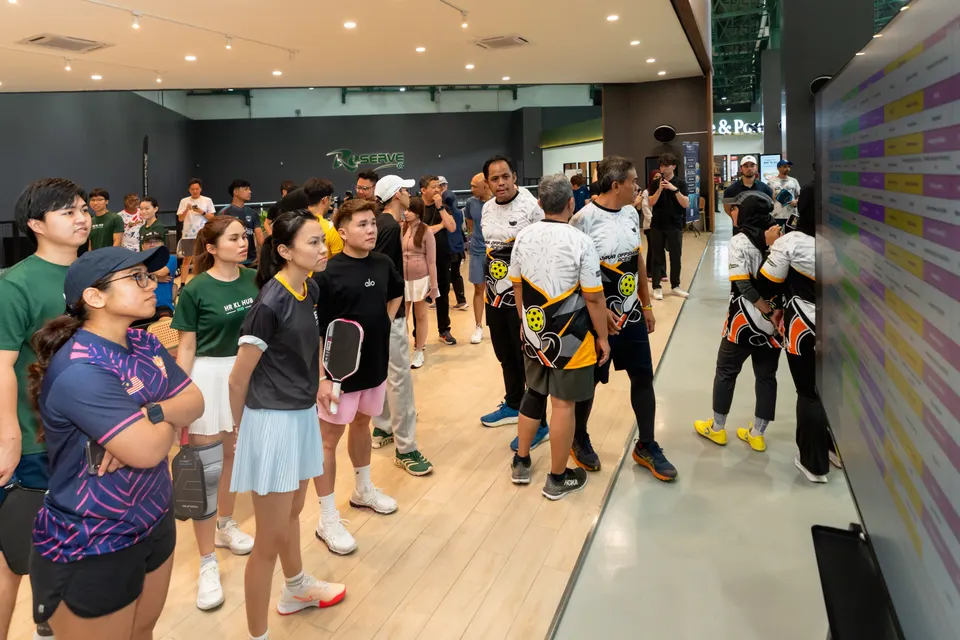 Players in sports kit gathered inside the venue before play