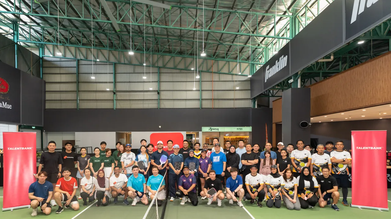 Players and supporters gathered on the pickleball courts for a group photo at a Game On fixture