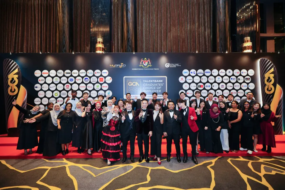 A large group in formal wear on stage at the Graduates' Choice Award night