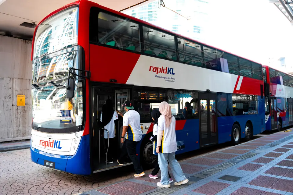 Visitors boarding a free RapidKL shuttle bus