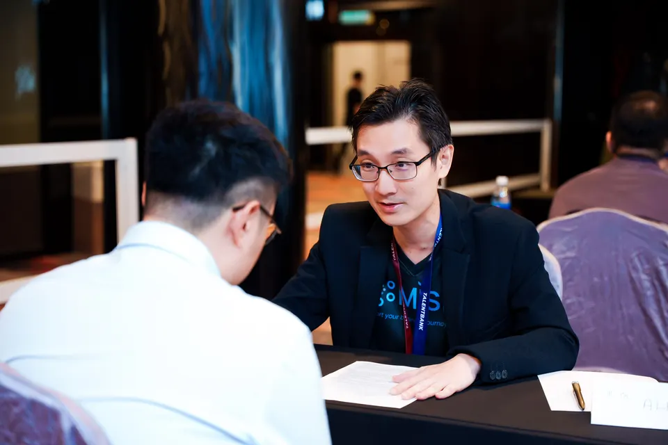 A mentor and a visitor talking across a table at the Talentbank Career Fair 2025