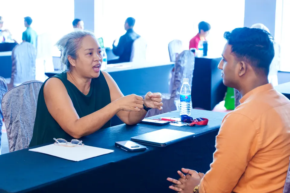 A mentor in conversation with a visitor at the Talentbank Career Fair 2025