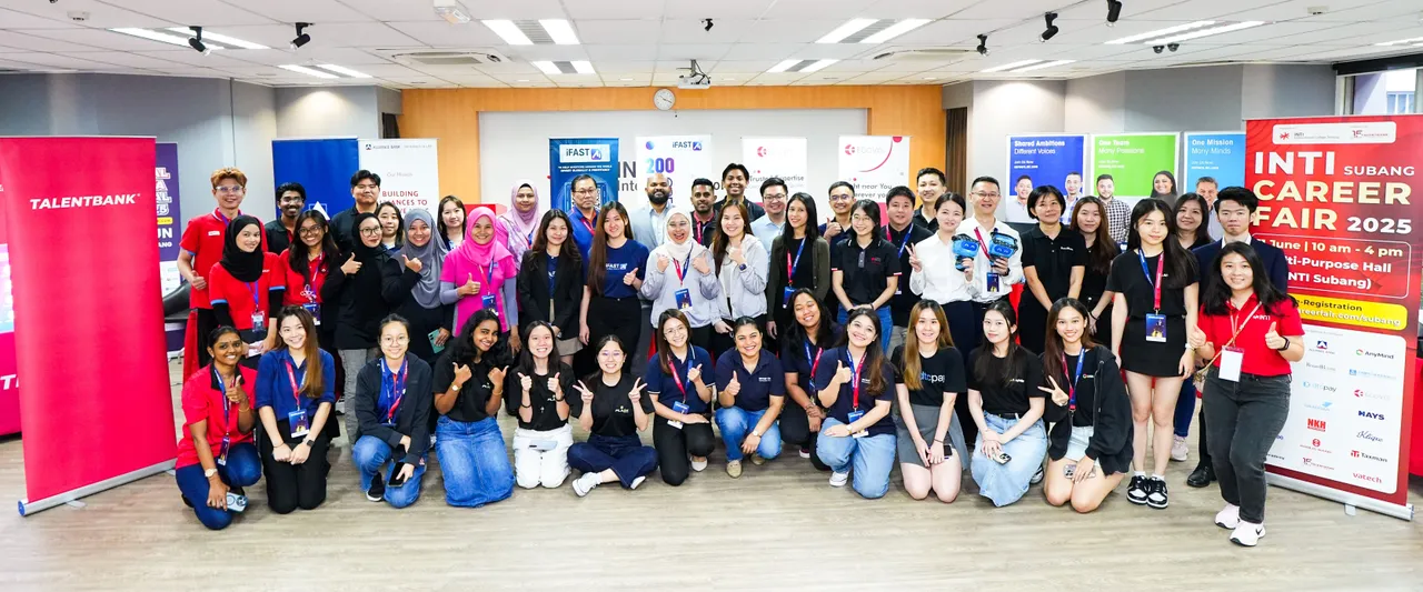Employers, students and the Talentbank crew gathered in a campus hall for a group photo beside the INTI Subang Career Fair banner
